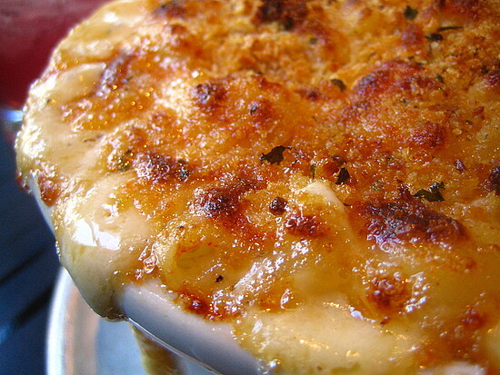 Indulge in this golden, cheesy baked macaroni and cheese with a crispy topping and herbs.