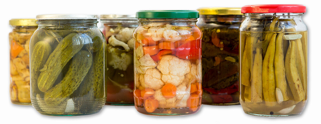 Vibrant collection of canned vegetables in glass jars showcasing home preservation and seasonal flavors.