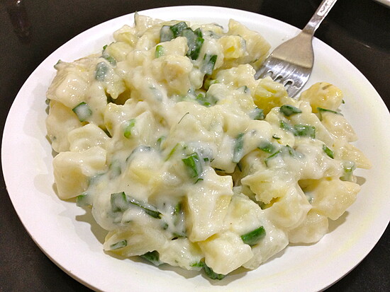 Creamy herb-infused potatoes in a rich sauce, perfect for a comforting meal.