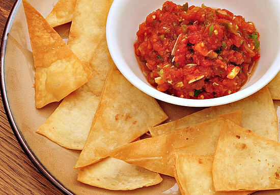 Crispy tortilla chips with fresh, chunky salsa for a delightful sharing experience.