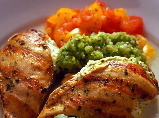 Grilled chicken with vibrant tomatoes and herbed puree for a fresh, healthy meal.