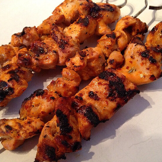 Succulent grilled chicken skewers with vibrant marinade, perfect for sharing at gatherings.