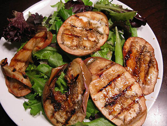 Grilled eggplant salad featuring fresh greens and vibrant vegetables for a healthy meal.