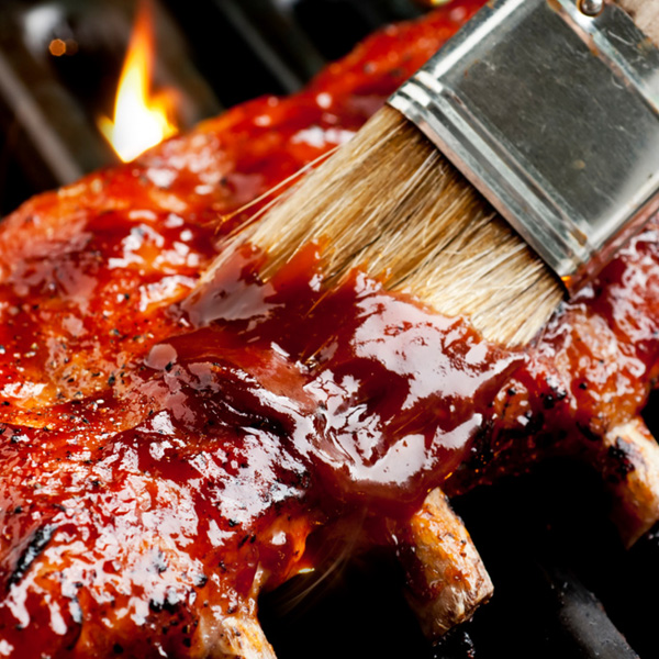 Succulent grilled ribs slathered in barbecue sauce, perfect for summer barbecues and gatherings.