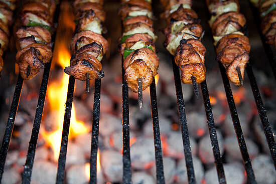 Delicious grilled kebabs with marinated meat and colorful vegetables sizzling over an open flame.