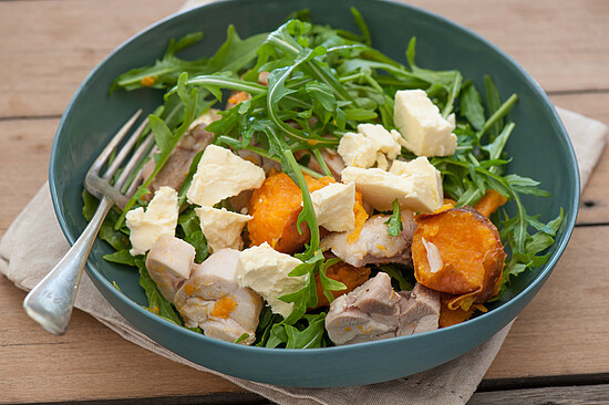 Colorful arugula salad with chicken, sweet potatoes, and feta, drizzled in vinaigrette. Perfectly nutritious!