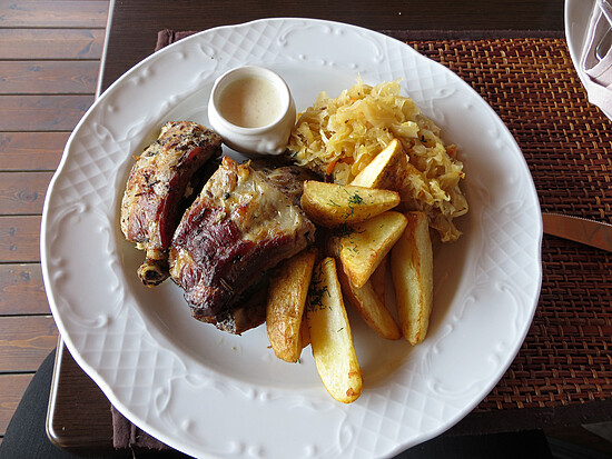 Succulent roasted meat and crispy potatoes served with tangy sauerkraut and creamy sauce.