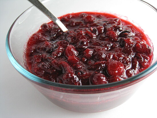 Festive homemade cranberry sauce in a glass bowl, rich in color and inviting textures.