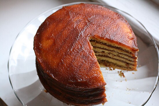 Exquisite layered caramel cake on a glass plate, perfect for celebrations and gatherings.