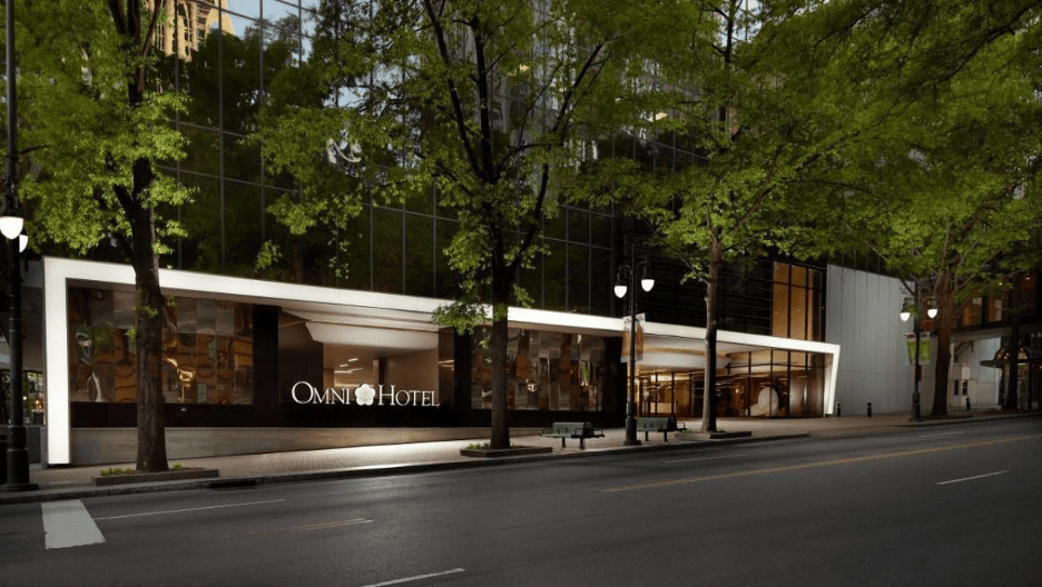 Omni Hotel entrance features modern architecture, inviting landscaping, and elegant design in an urban setting.