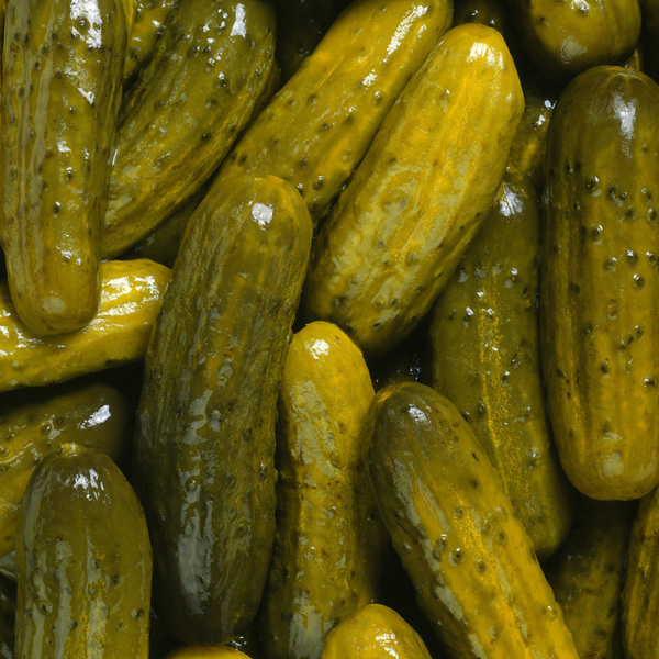 Vibrant cluster of assorted pickles ready for summer picnics and flavorful culinary creations.