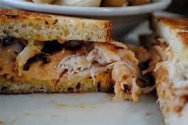 Delectable shredded chicken sandwich on golden toasted bread, perfect for comfort food lovers.